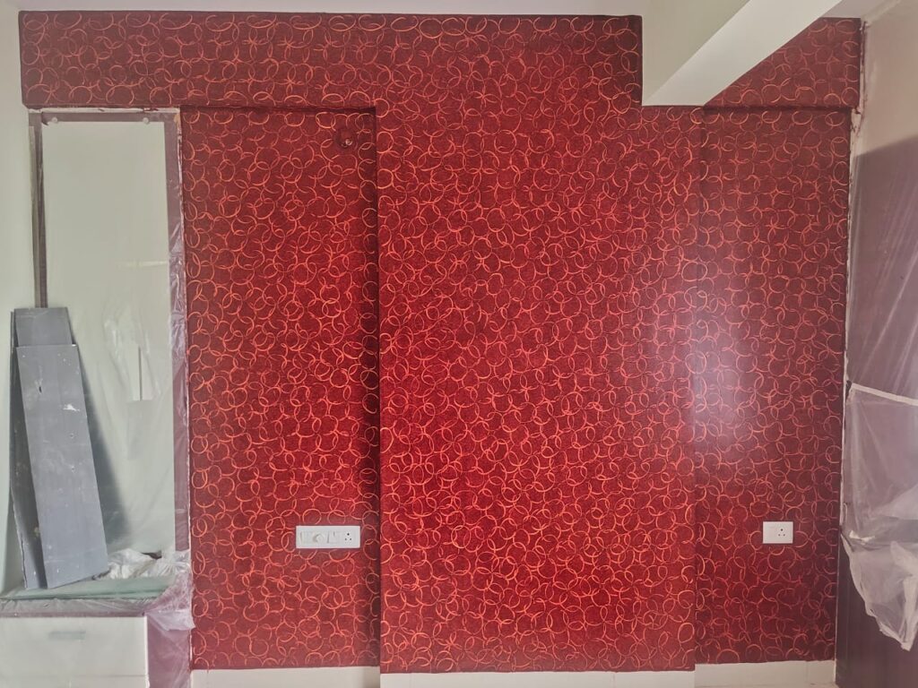 A room with a red wall and a door.