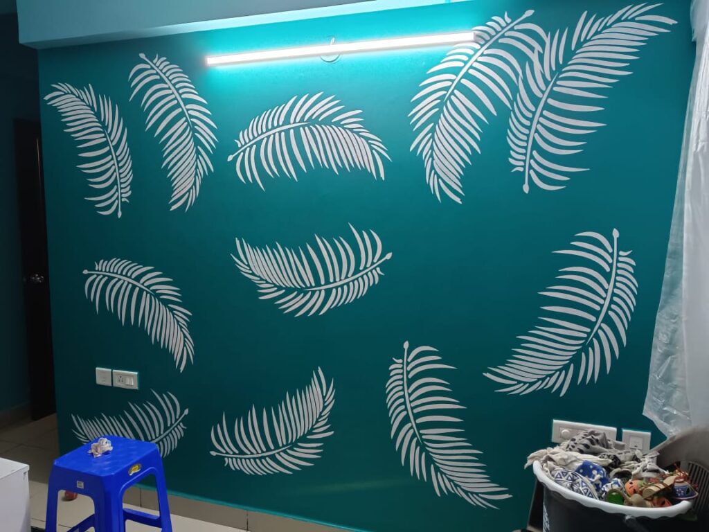 A wall with palm leaves painted on it, adding a tropical touch to the space.