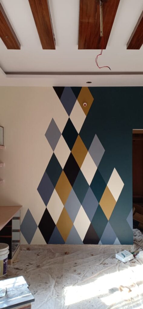 A room with a large wall painted with geometric designs.