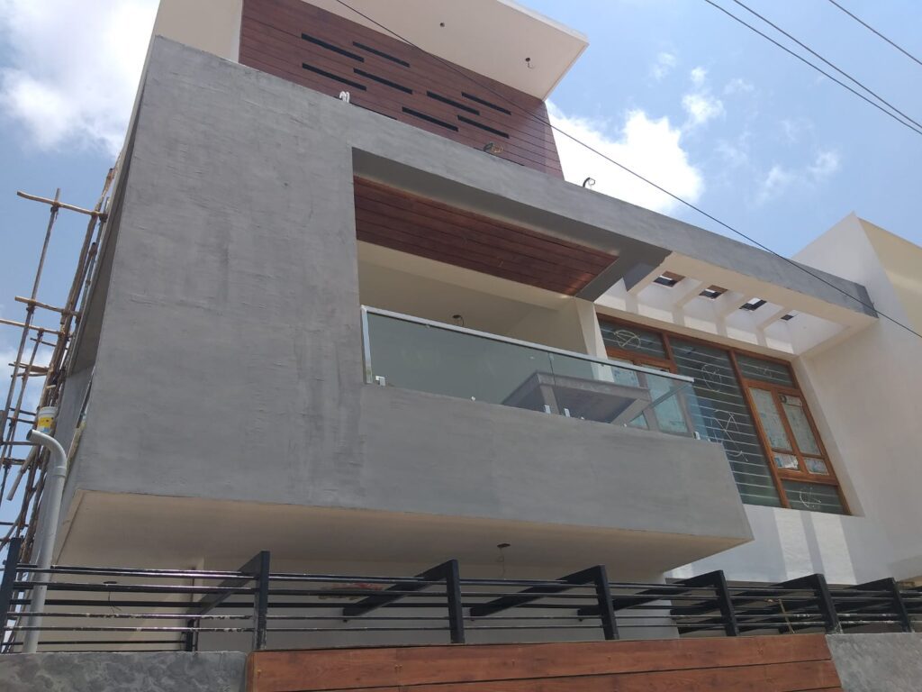 A modern house with a balcony overlooking the city skyline.